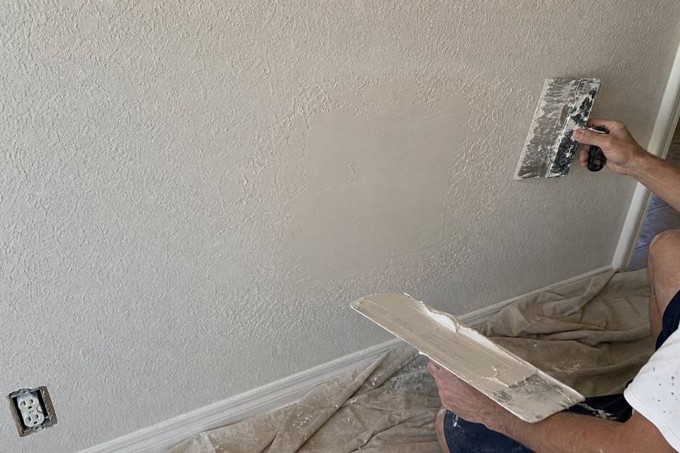 Texture matching and drywall patch repair in progress for Vero Beach drywall projects